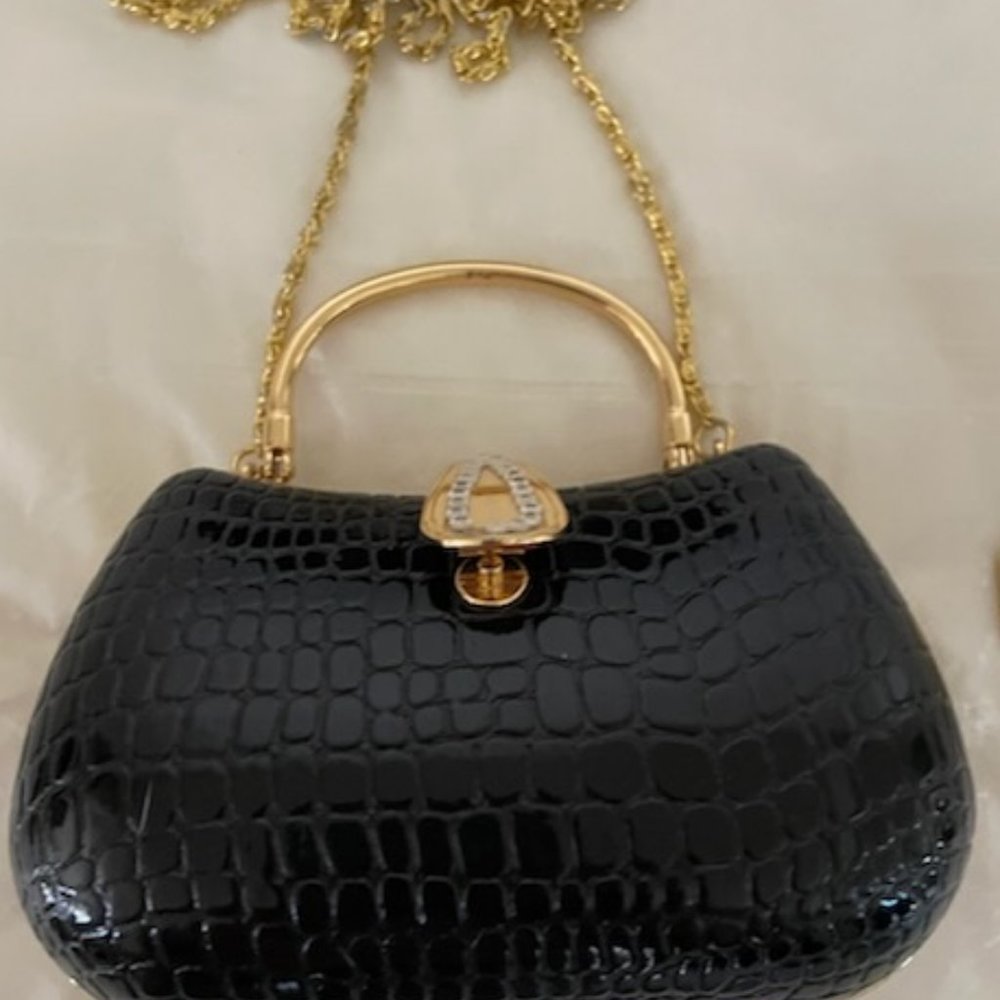 BLACK HARD COVER EVENING PURSE, COMB INSIDE IS MARKED JUDITH LEIBER, ITALY